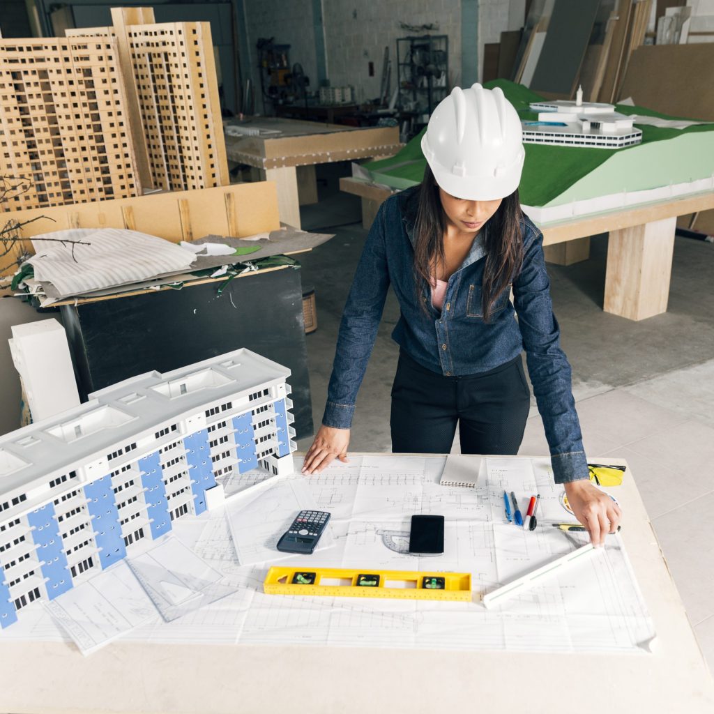 african-american-lady-safety-helmet-standing-near-model-building-scaled.jpg